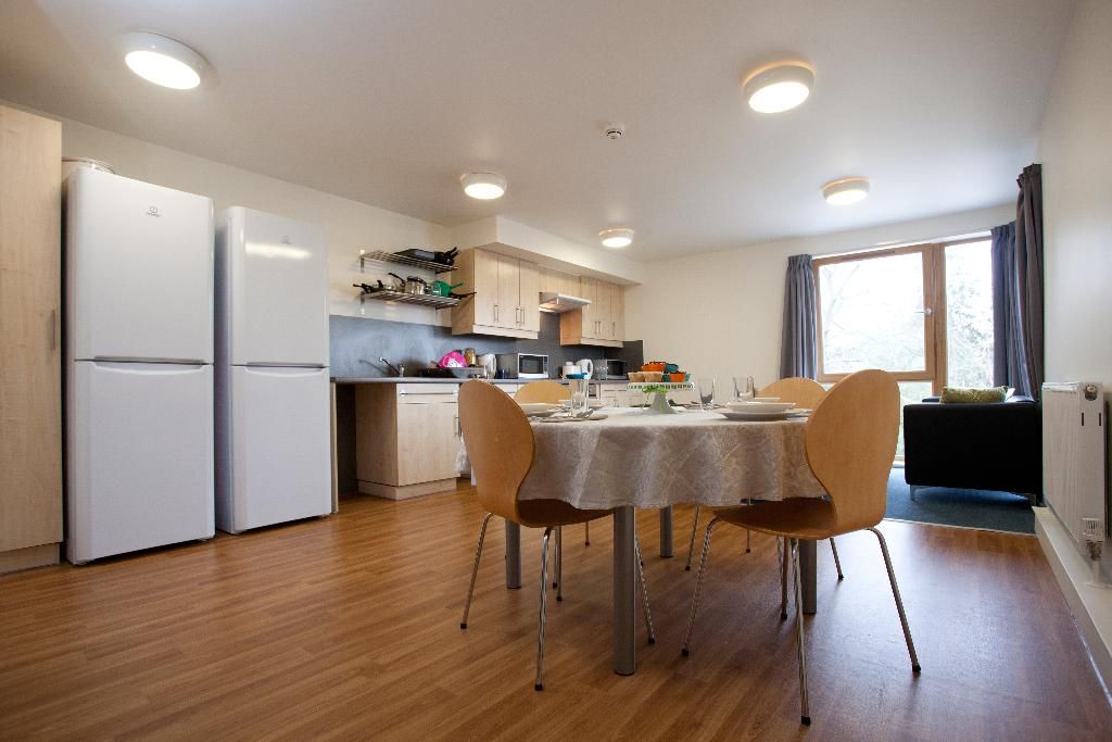 An open kitchen and dining space with warm wooden flooring